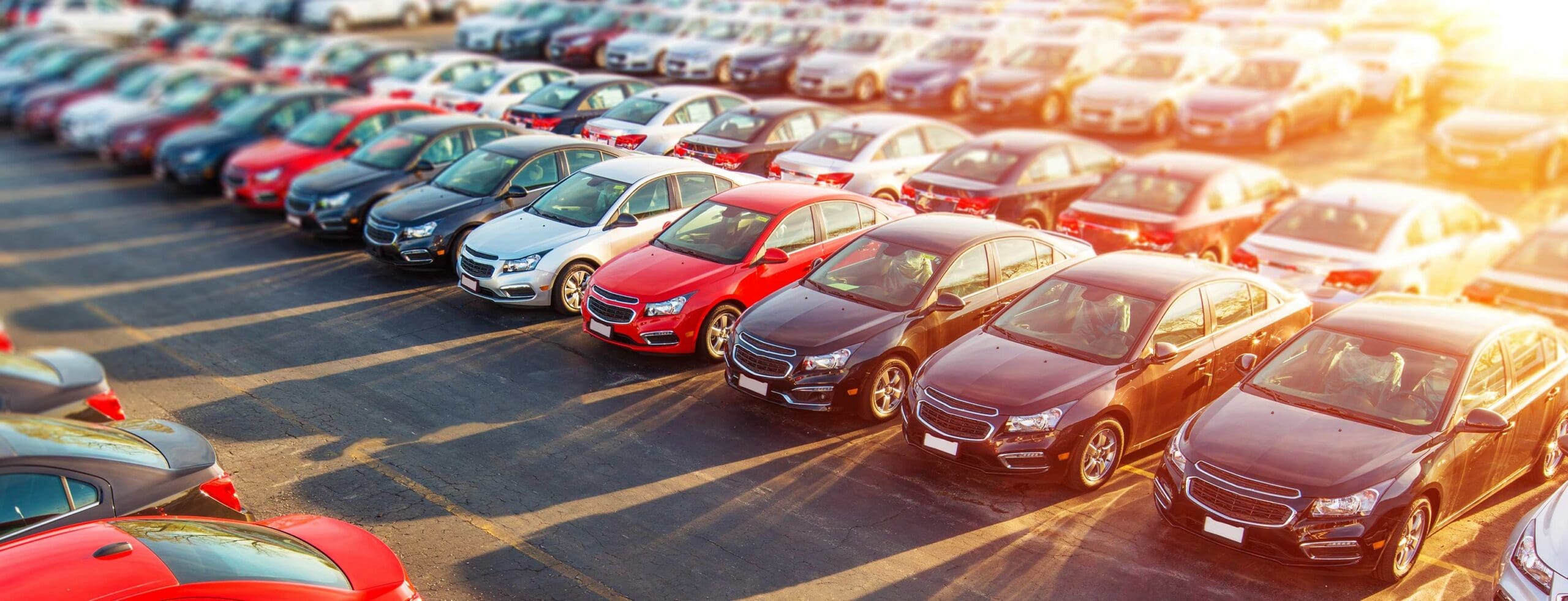 rows of cars at a dealership